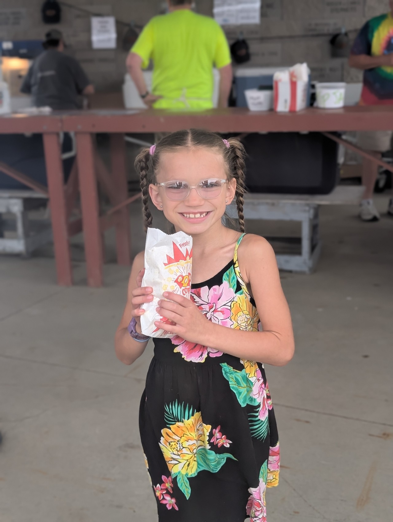 A girl enjoying free popcorn at the PLA FunRaiser