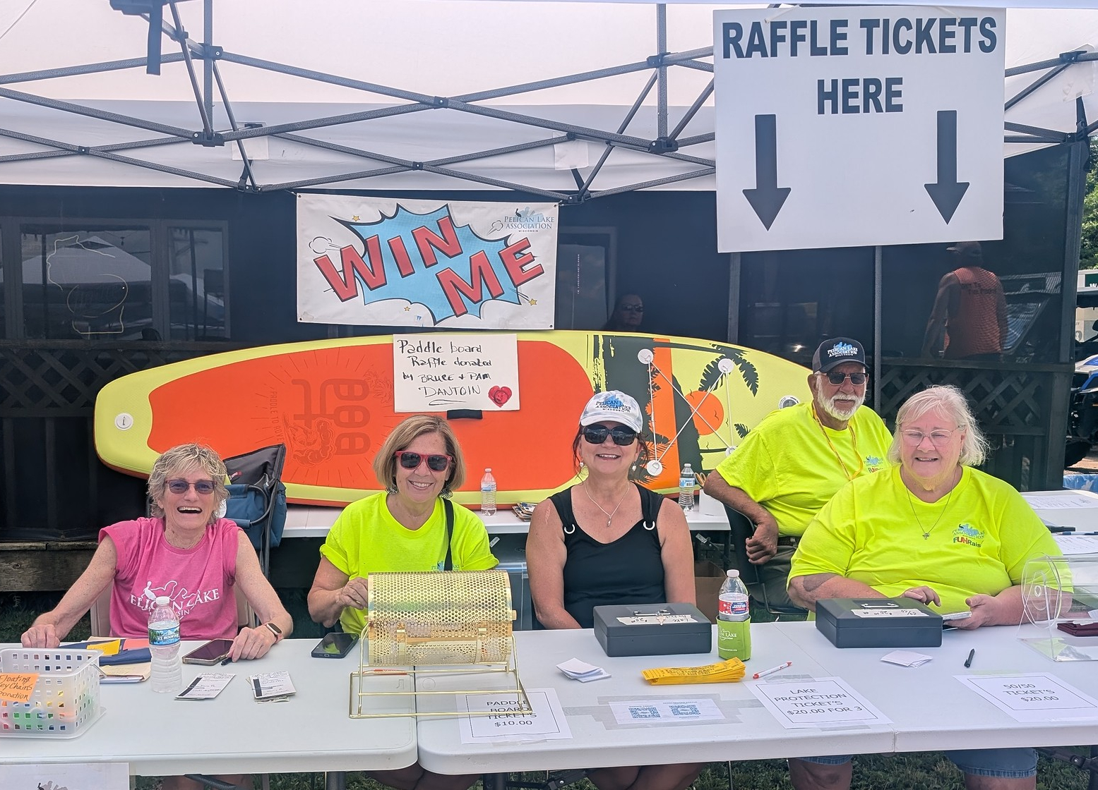 Four PLA volunteers at the raffle table at the Ski Show event.