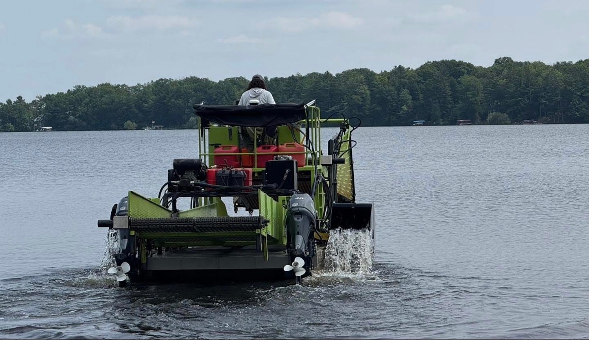 Aquatic Plant Managment harvesting weeds on their special harvester boat